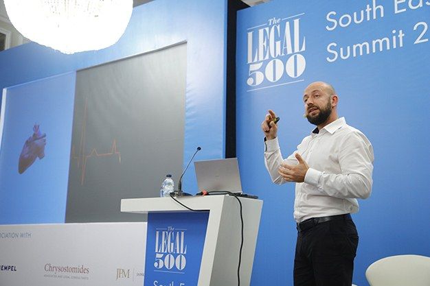 Alexander Balabanov presenting from the podium at a leadership summit